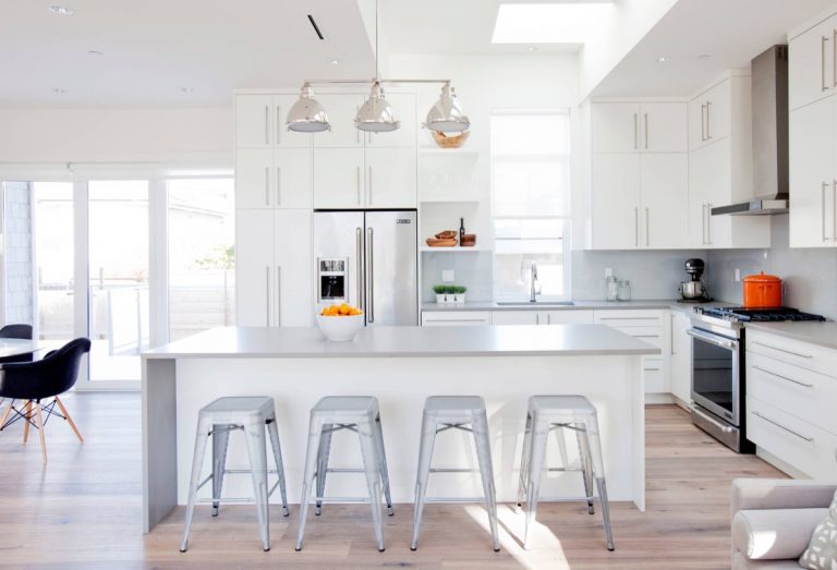 White-contemporary-kitchen-light-maple-floors-grey-countertops